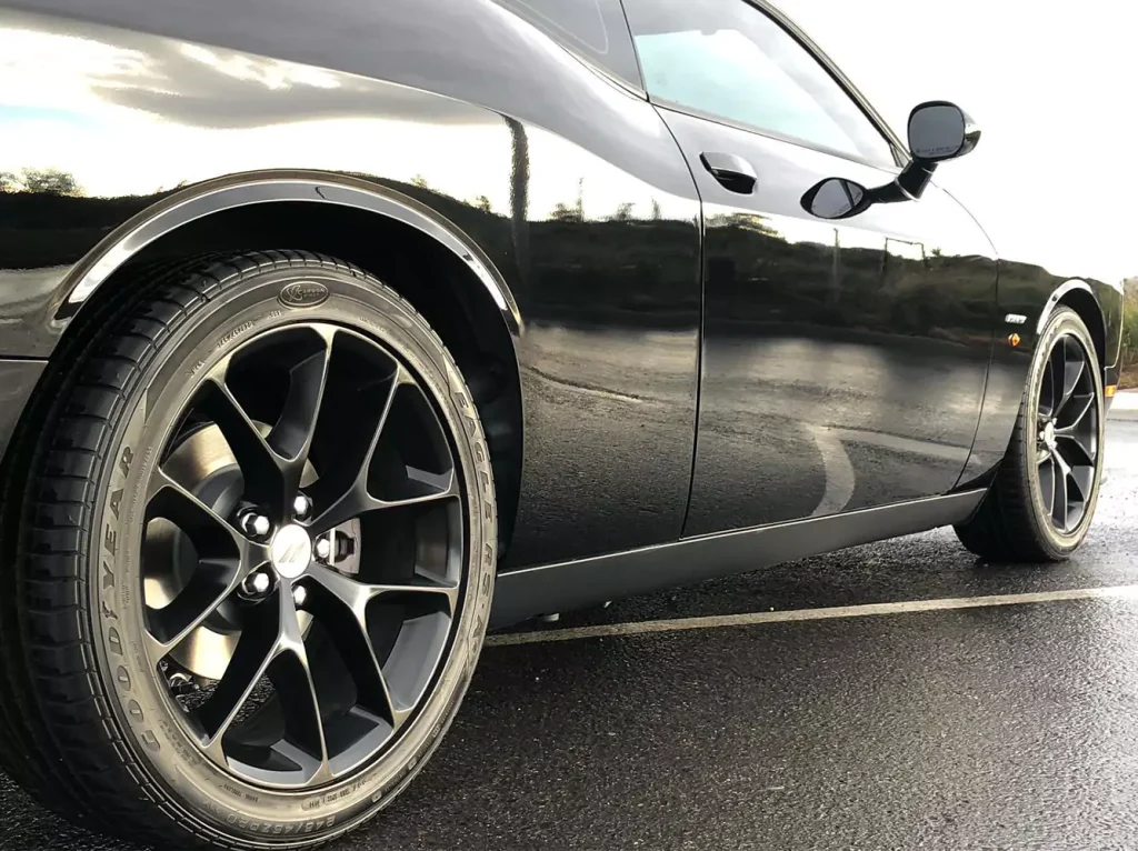 A black shiny car parked outside