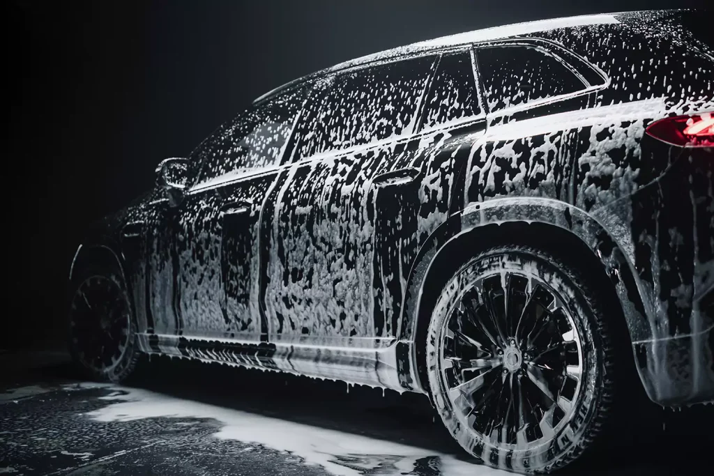 A black car being washed with soap