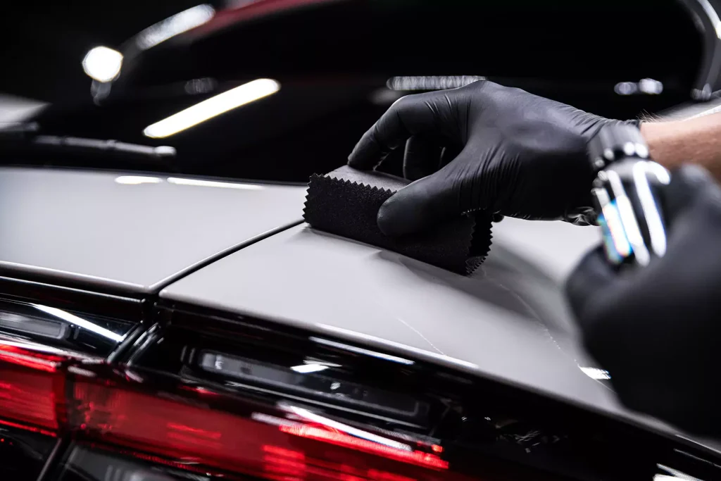 A hand carefully detailing the car