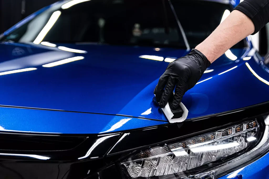 A blue car being wiped